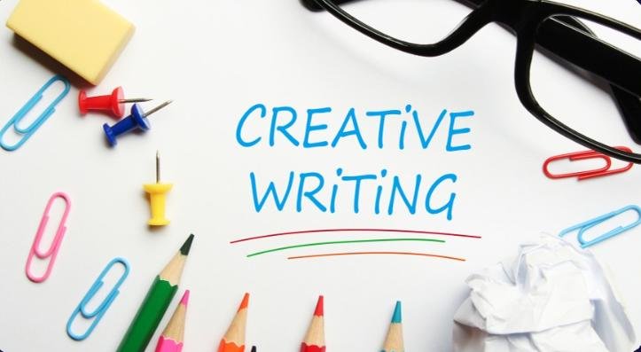 Creative writing concept with colored pencils, paper clips, push pins, glasses, and handwritten text.
